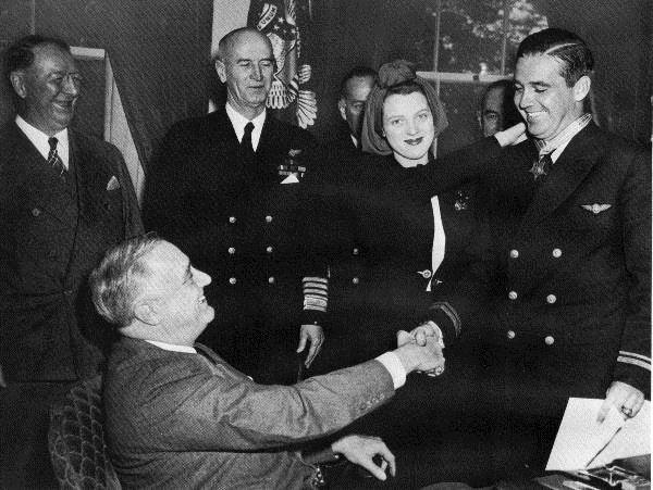 At left is Illinois State Society board member Frank Knox, a former publisher of the Chicago Daily News and Secretary of the Navy for President Franklin D. Roosevelt. FDR presents the Medal of Honor in 1942 to Navy pilot Butch O'Hare from Illinois. Sadly Butch was killed in action in 1943 and in 1949 the Orchard Field near Chicago was named O'Hare International Airport in his honor.