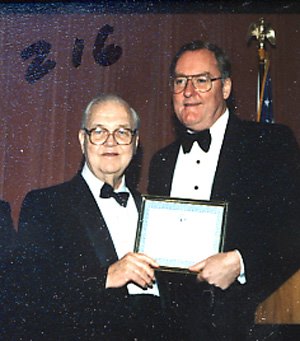 Mike Howlett and Gov. Thompson with Award
Let to right: Former Illinois Secretary of State Michael J. Howlett (D-Chicago) receives the Illinois State Society Outstanding Public Service Award from the society's honorary Chair, Gov. James R. Thompson (R-Chicago) at the Society's Inagural Gala on Jan. 19, 1989.

Howlett and Thompson were opposing candidates for governor of Illinois in 1976. Mike Howlett had a long and distinguished record of public service to Illinois. He served as Illinois Auditor of Public Accounts for 12 years from 1961 to 1973 and as Secretary of State for four years from 1973 to 1977. As a young man, Mike played water polo for the Illinois Athletic Club and was on ten championship teams. He served in the Navy in World War II.